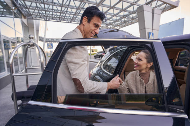 Chauffeur greeting an arriving guest at the airport canopy
