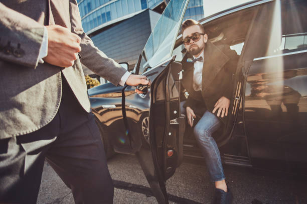 Executive client stepping into a black SUV outside a downtown tower
